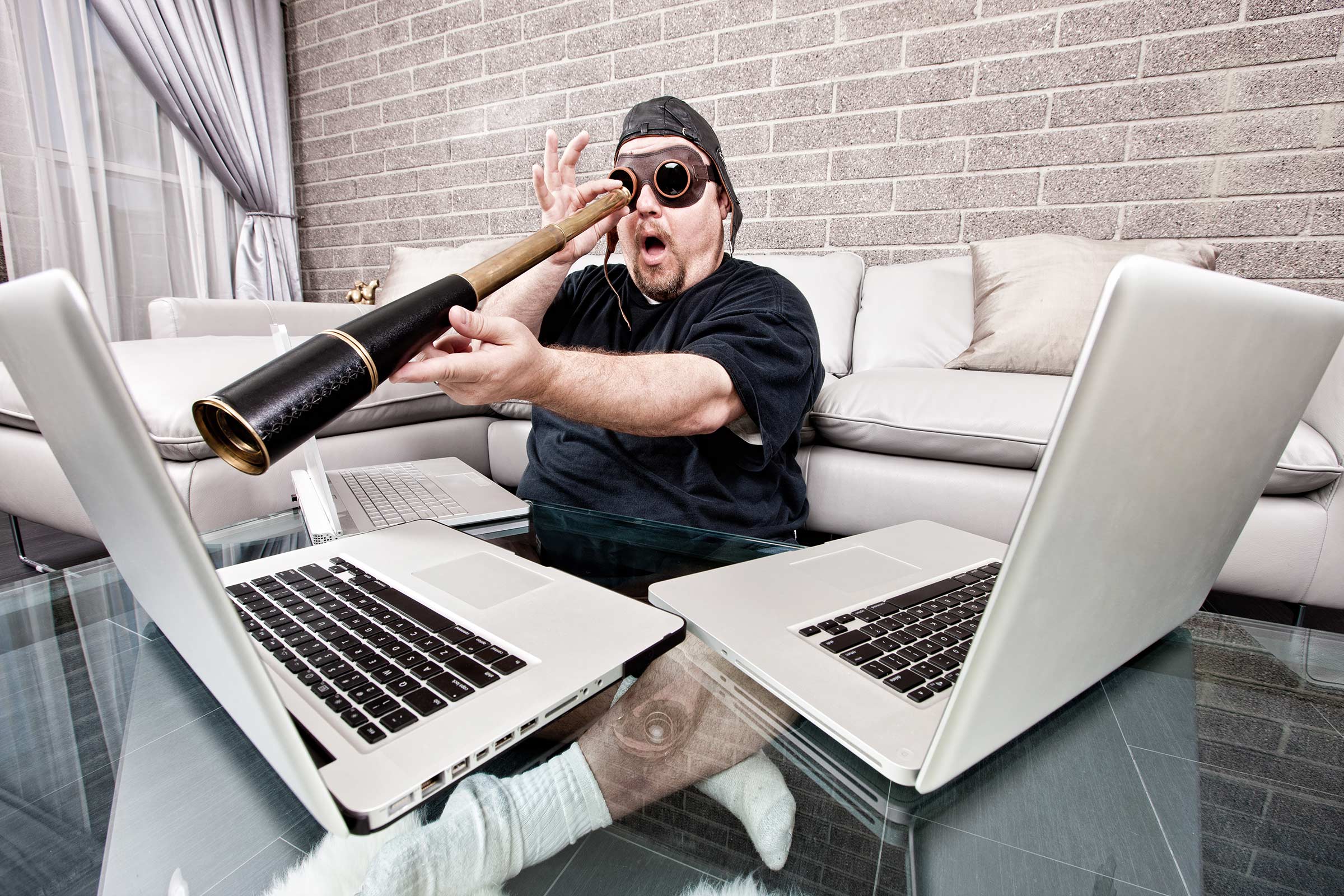 Man using a telescope to improve your search engine ranking in a modern living room.
