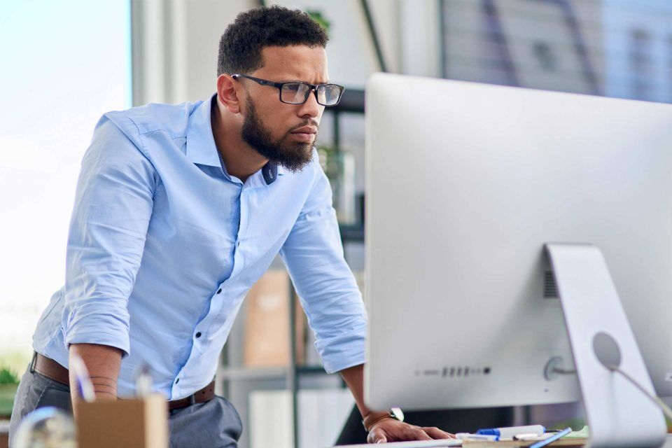 Man in blue shirt, wearing glasses, pondering what is a permalink on screen.