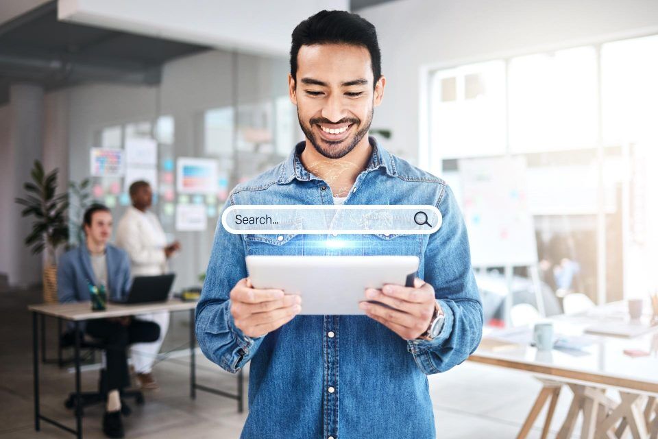Man using a tablet in an office, highlighting mobile-first design and search.