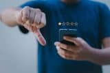 Person gives a one-star review on phone, showing a poor customer journey.