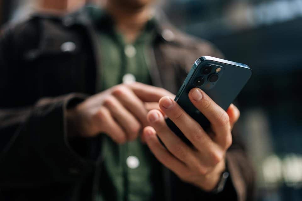 Person using a smartphone outdoors, exploring lead magnets that work.
