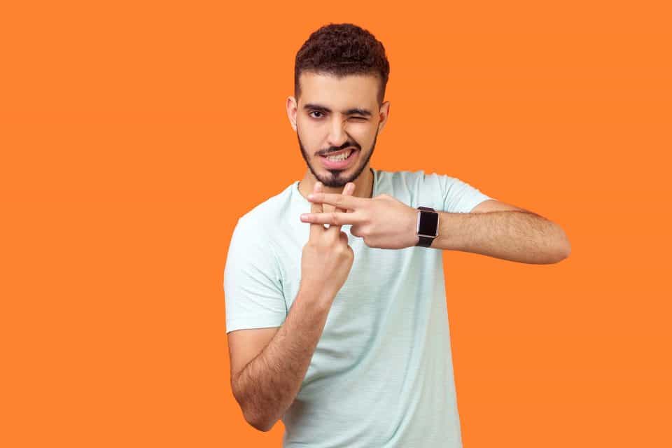 Instagram hashtags on a vibrant orange backdrop with a gesture.