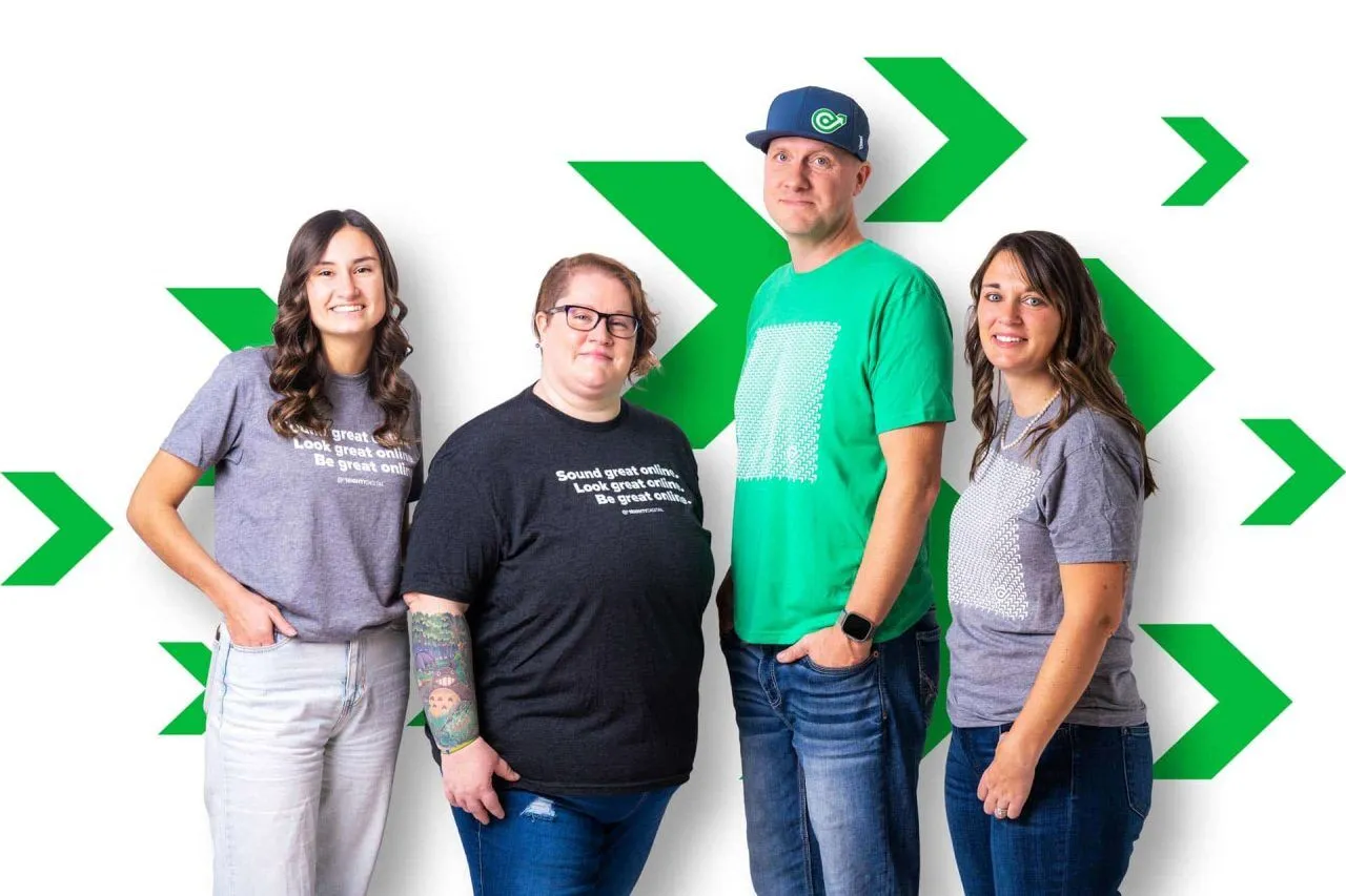 Four people standing in casual attire with green arrows in the background.