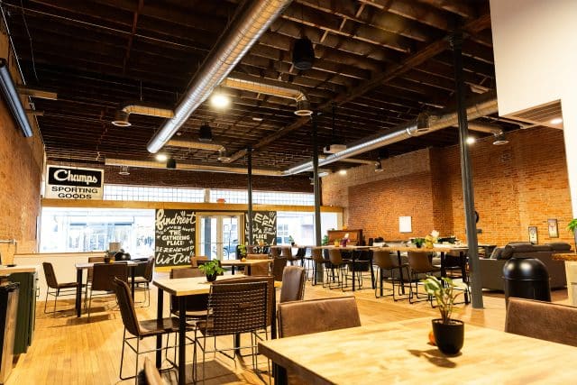 The Gathering Place: Spacious cafe with wooden tables and exposed beams.