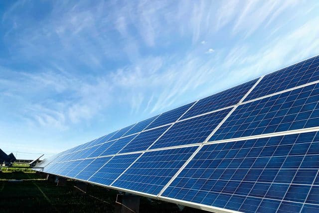 Advanced solar panels under a blue sky with minimal clouds.
