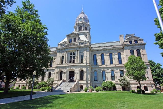 A large ALL-IN Kosciusko courthouse with a central dome and clock tower.