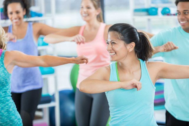 At Debra Colliers School of Dance, people smile and dance together in the gym.