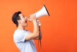 Person shouting into a megaphone, boosting small business marketing.