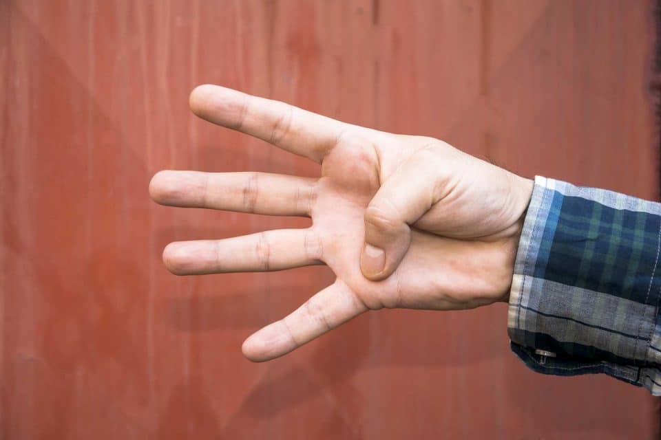 Rebranding: Hand showing three against a bold red backdrop.