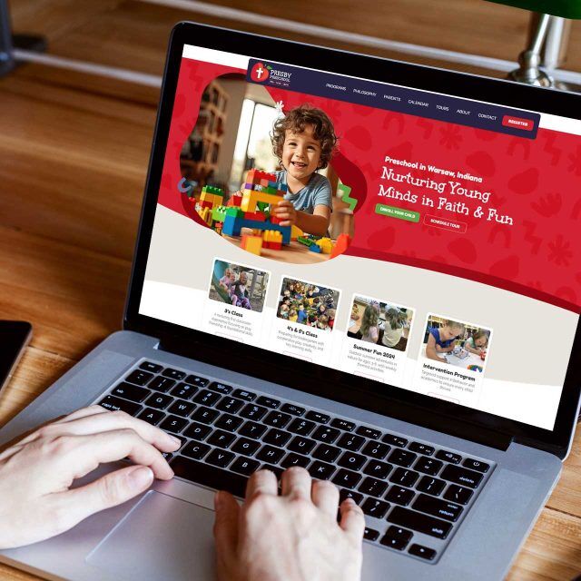 Person viewing the Presby Preschool website on a laptop screen.
