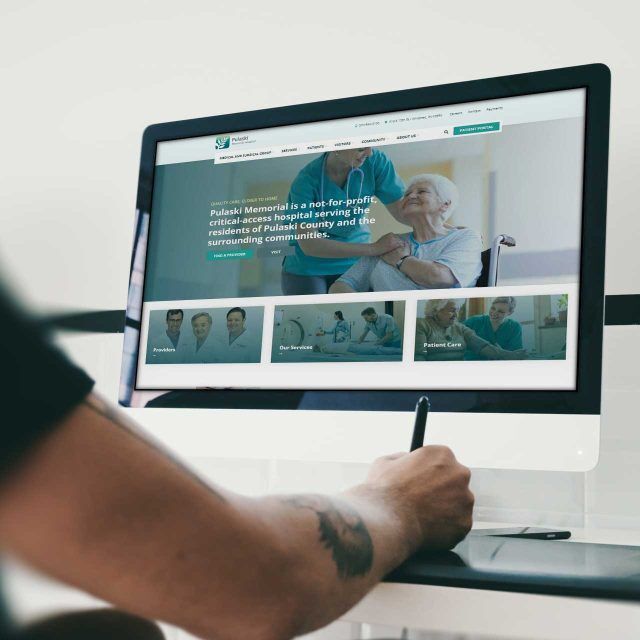 Person using a stylus on Pulaski Memorial Hospitals website on a computer.