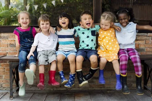 Six kids in bright outfits and boots, part of United Ways Whitley efforts.