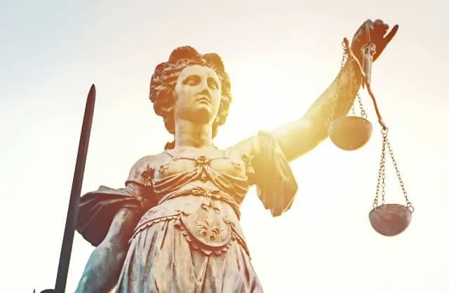 Lady Justice, emblem of Vanderpool Law Firm, holds scales and a sword.