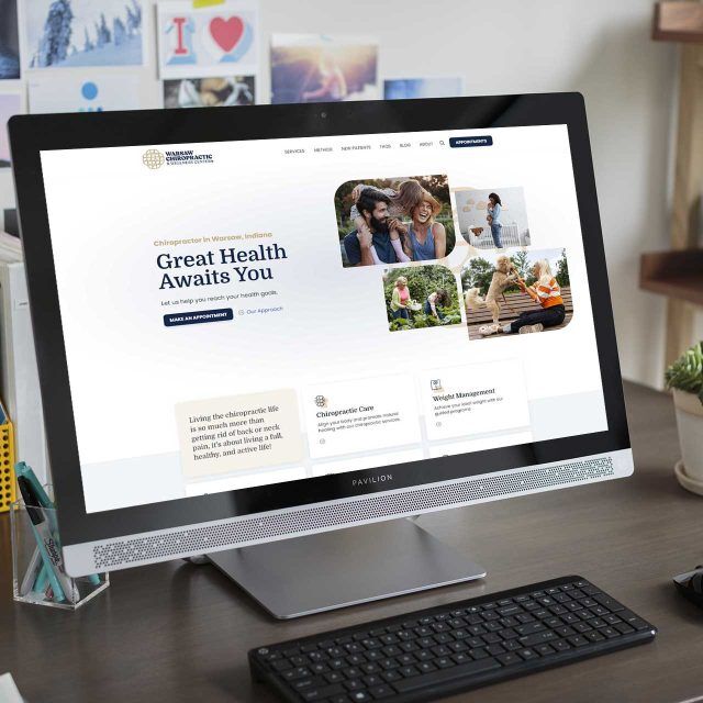 A website for Warsaw Chiropractic on a desktop in a cozy home office.