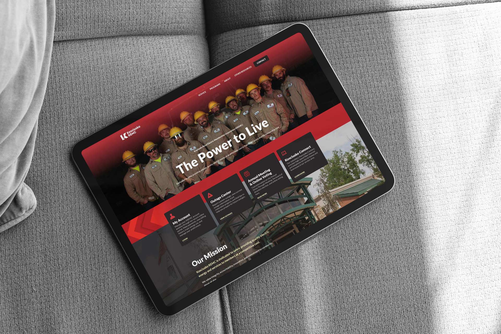 Tablet displaying a website with workers in hard hats and the text The Power to Live.