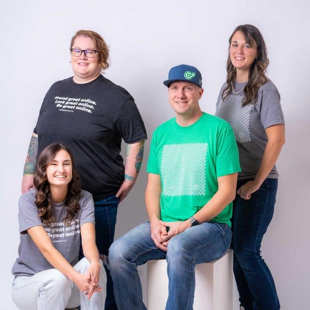 Four people smiling in casual shirts, ready for email marketing success.