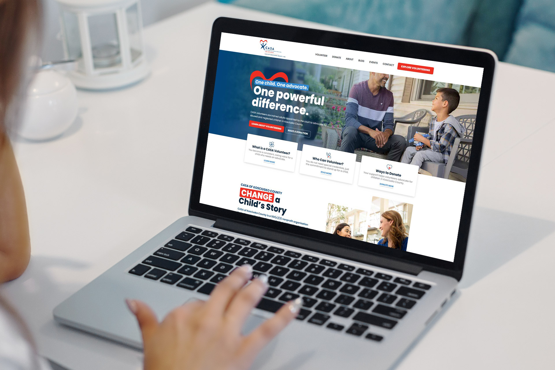 Person using a laptop displaying a nonprofit organizations website homepage.