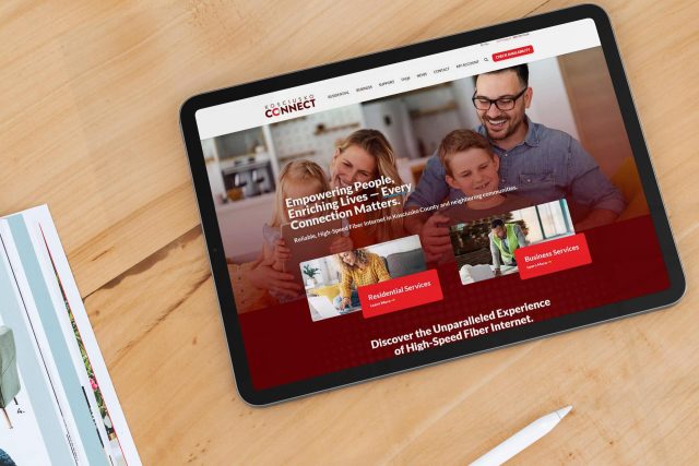 Tablet showing Kosciusko Connects high-speed internet site on a wooden table.