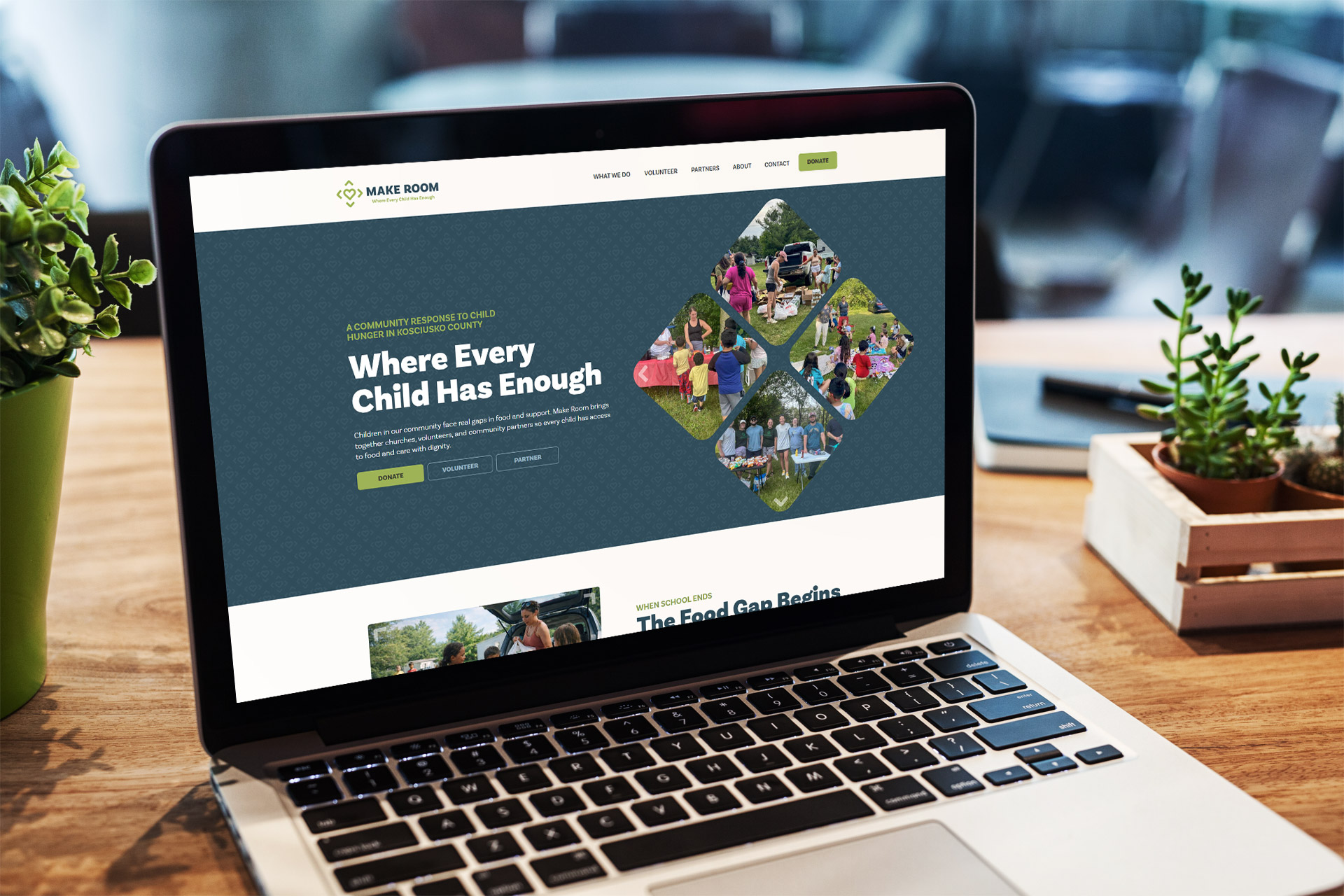 Laptop on desk displaying a charity website with the text Where Every Child Has Enough.