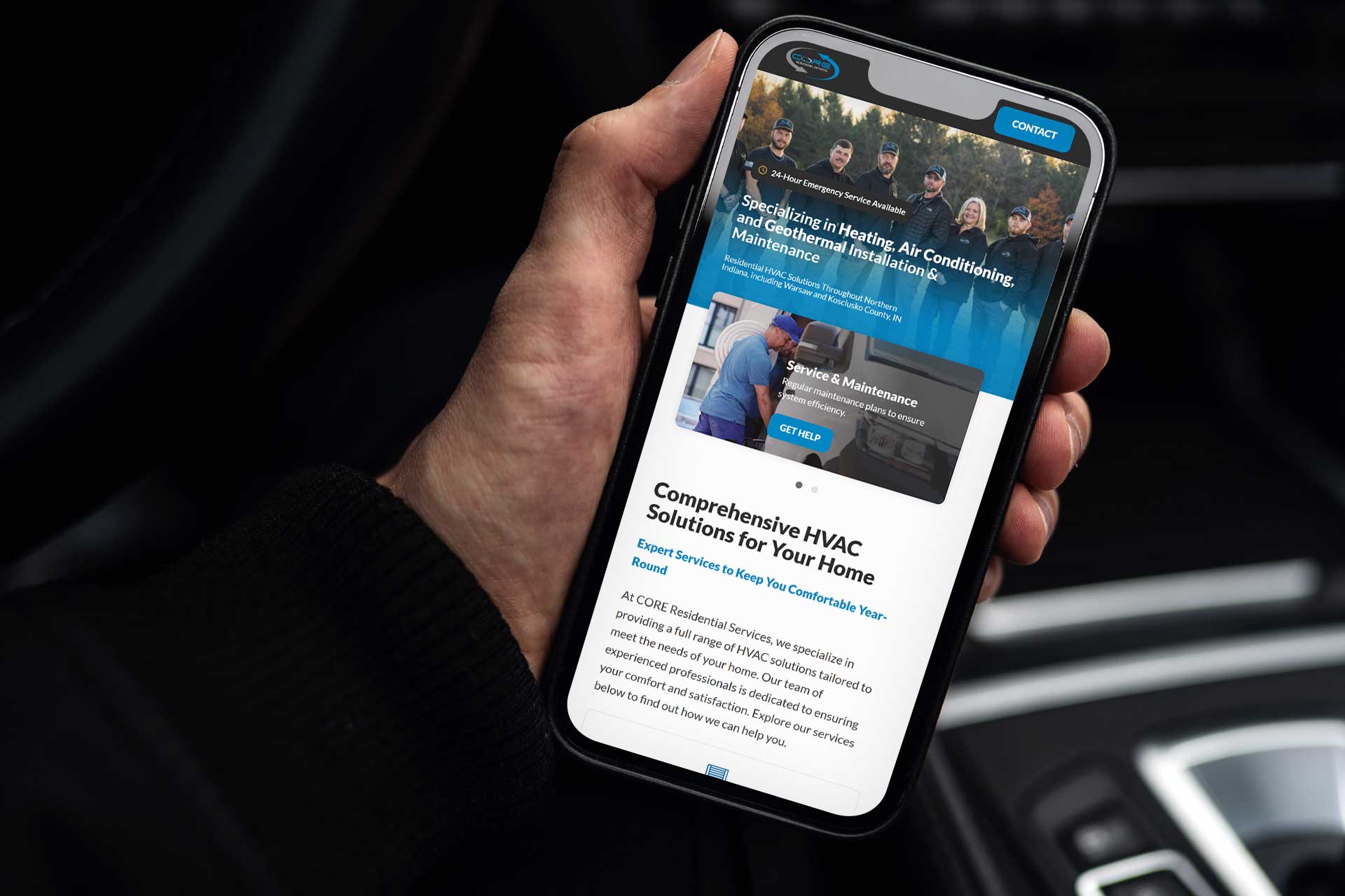 Hand holding a smartphone displaying the CORE Residential HVAC service site.