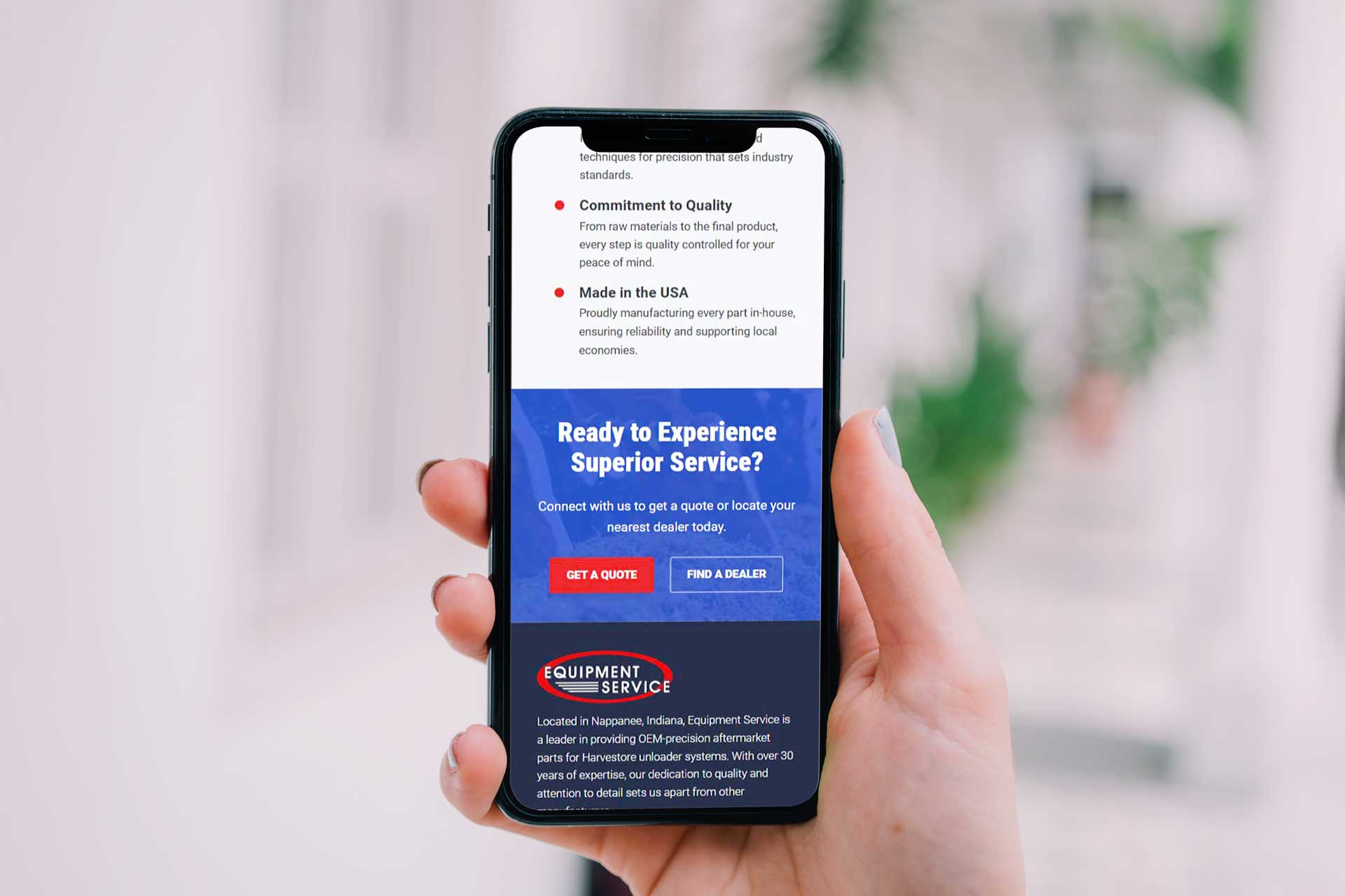 Hand holding smartphone displaying a service website with quote and dealer options.