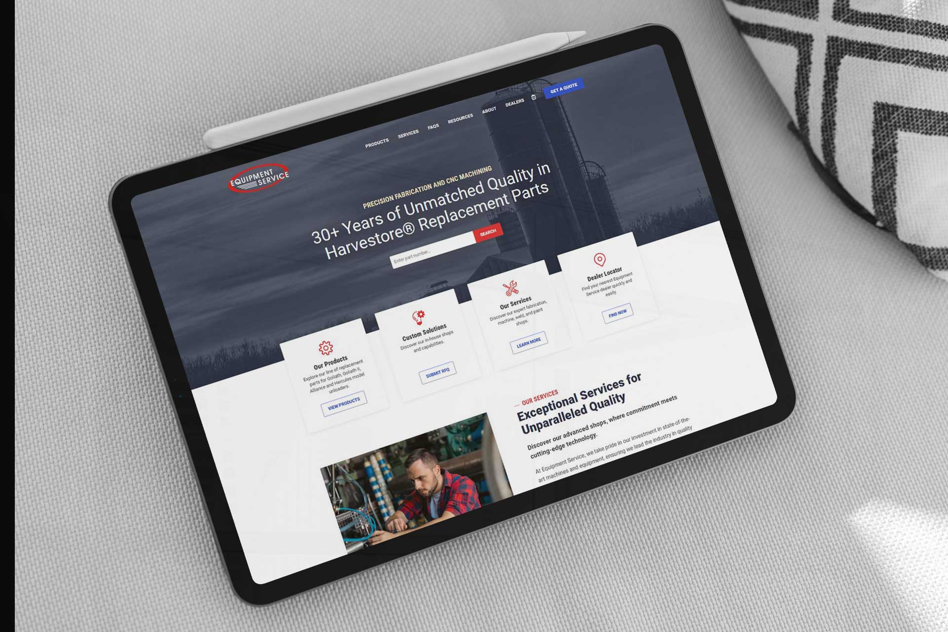 Tablet displaying a website for Harvestore replacement parts on a gray fabric surface.