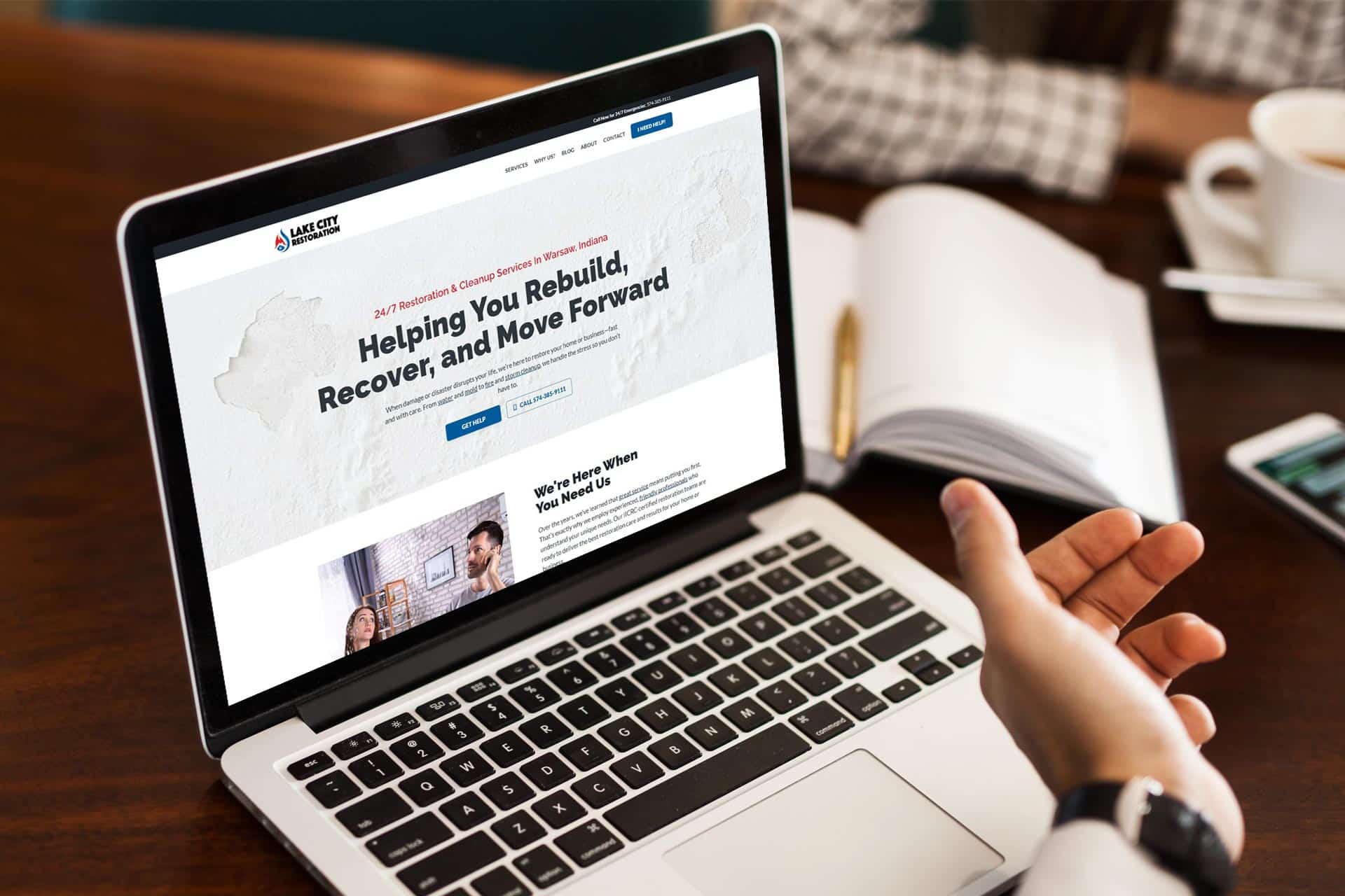 Person browsing Lake City Restorations website on a laptop screen.