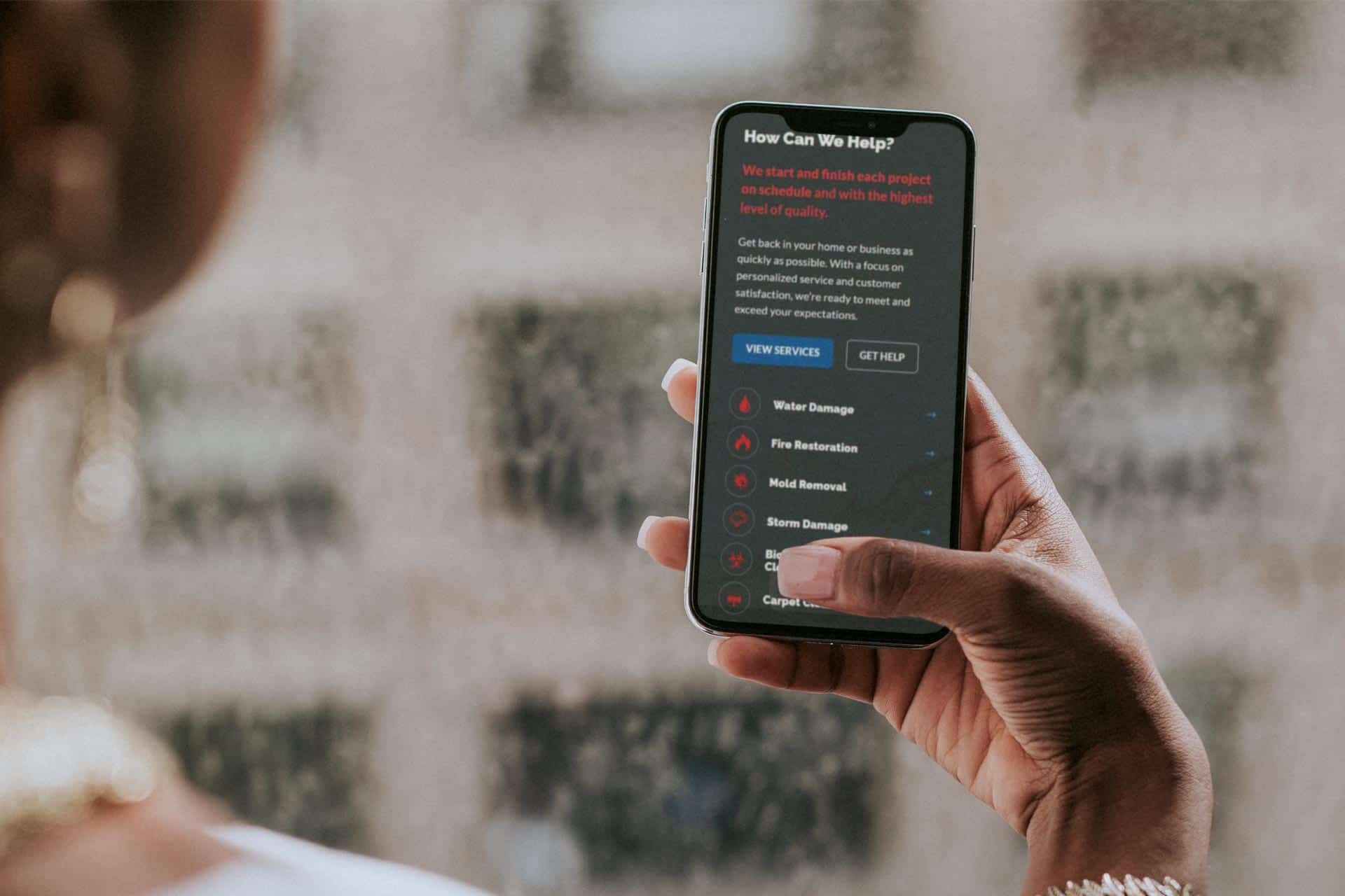 Person using a Lake City Restoration app on their smartphone.
