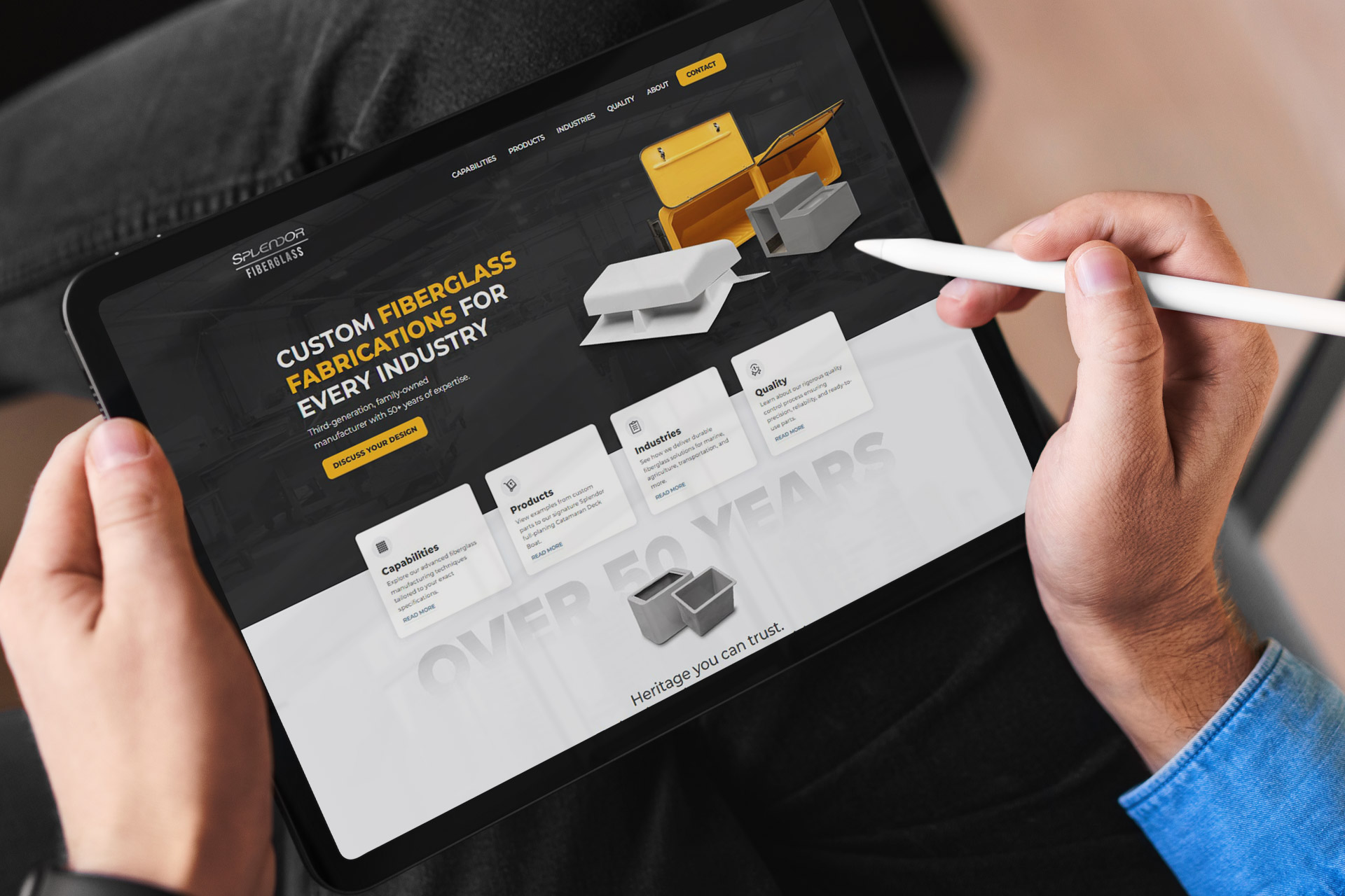 Person holding a tablet displaying a fiberglass fabrication companys website.