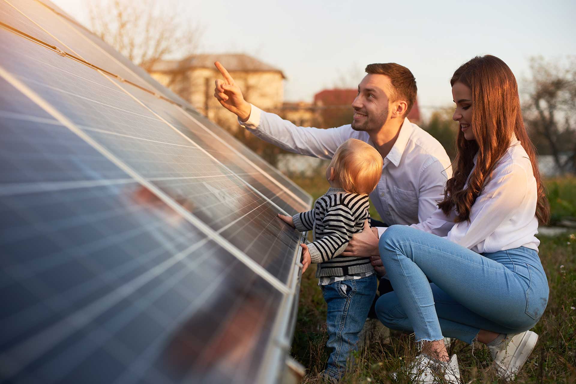 Family observing advanced solar panels outdoors.