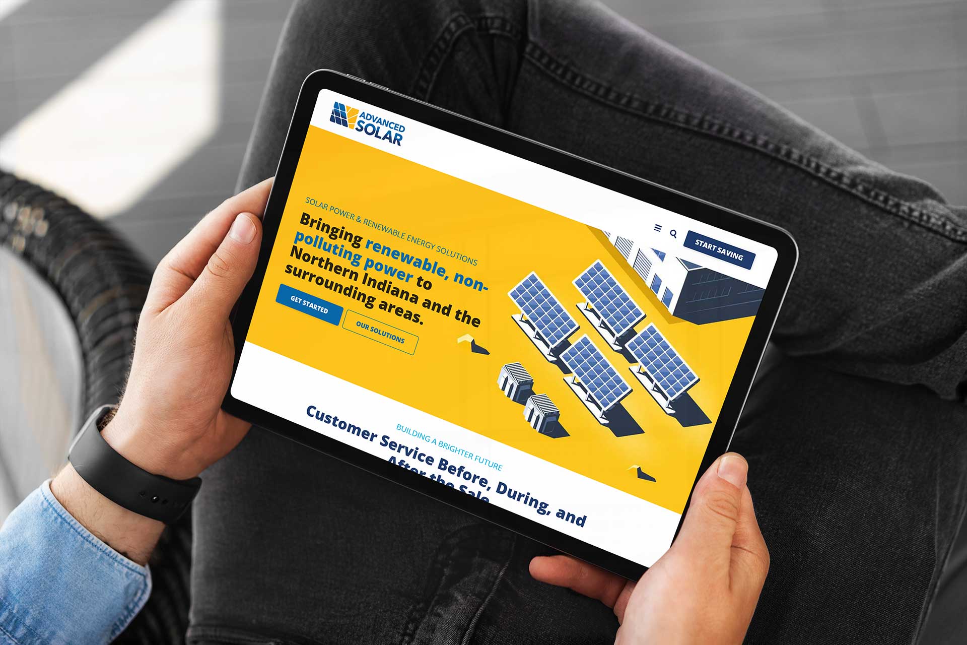 Person holding a tablet showing Advanced Solars website.