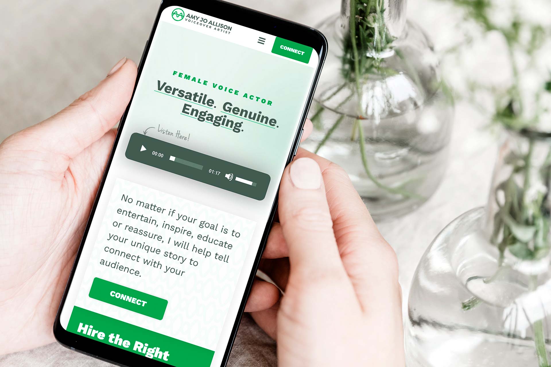 Person holding a smartphone displaying a voice actors website.