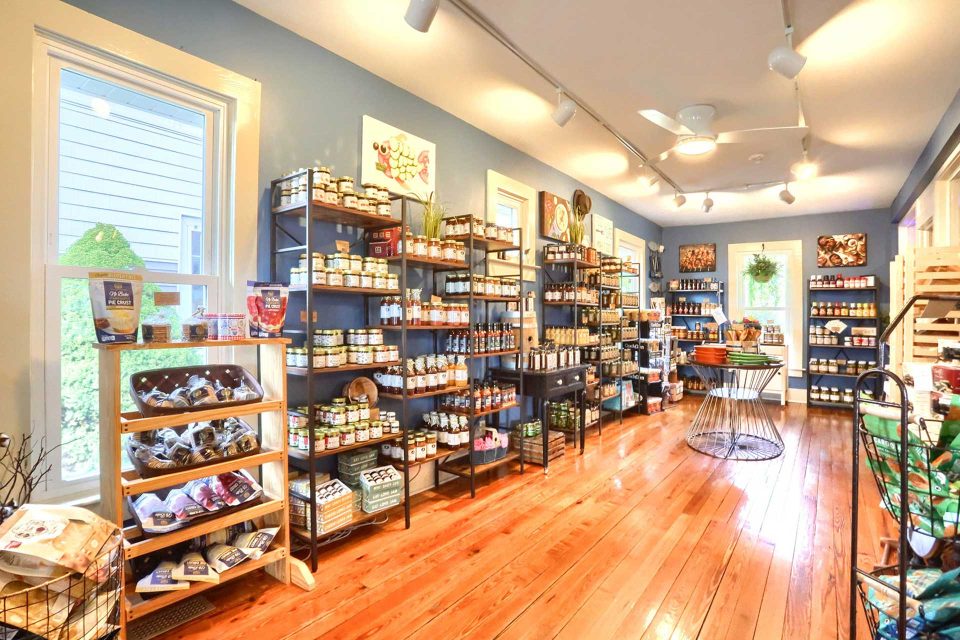 A bright room filled with shelves displaying various food products.