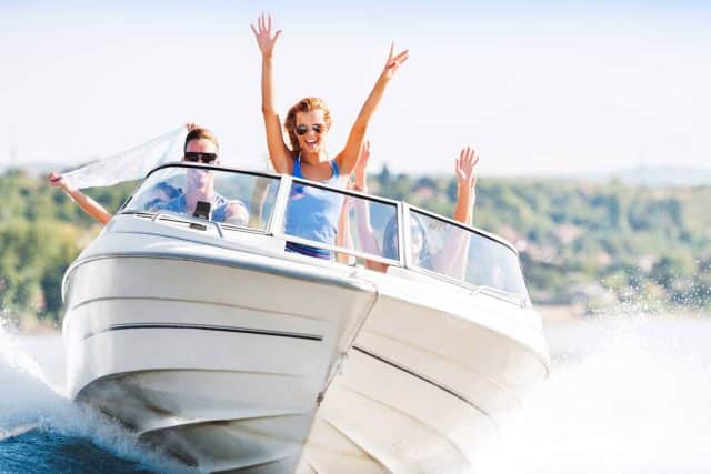 People enjoying a speedboat ride on a sunny day.