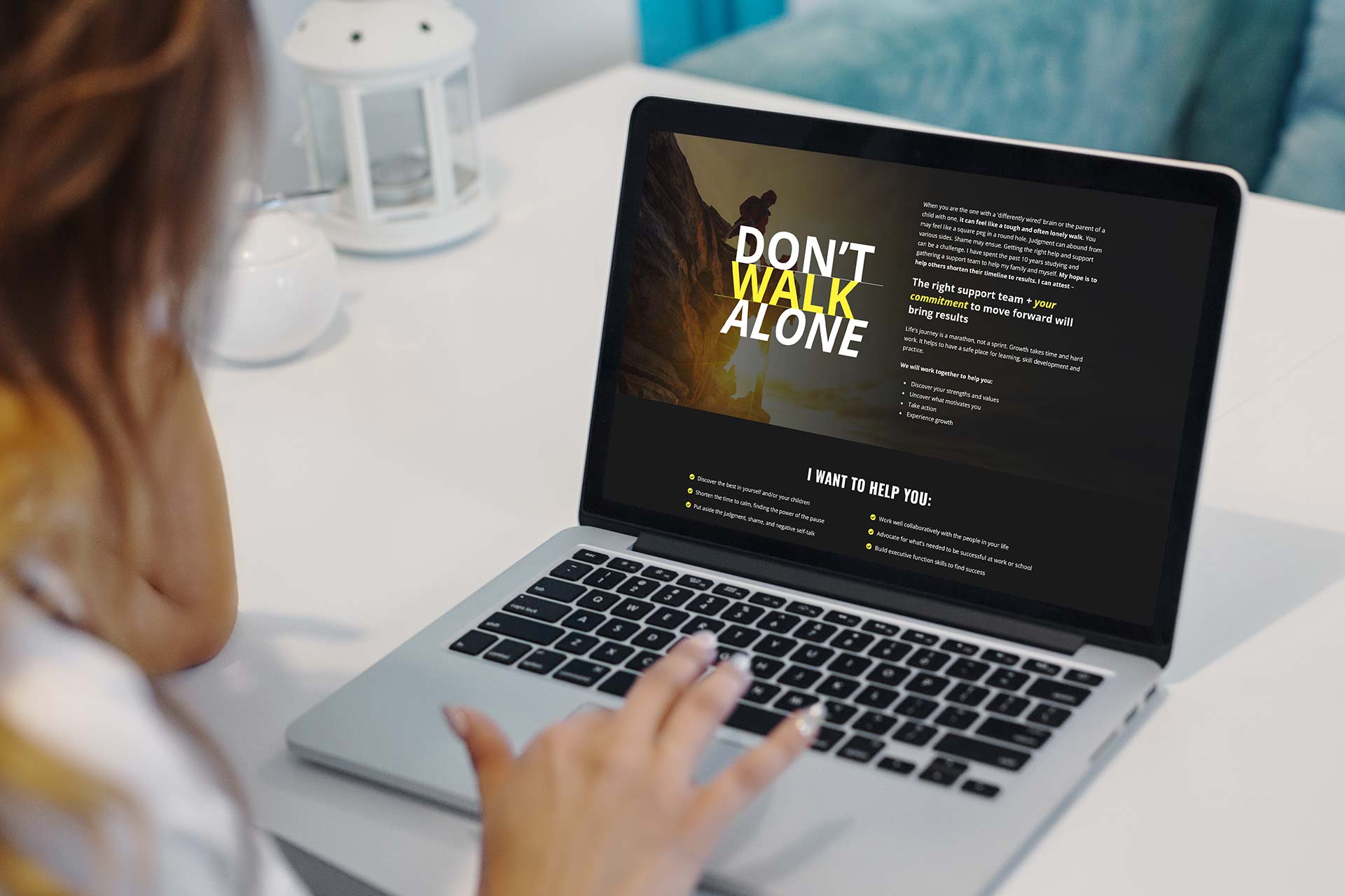 Person using a laptop displaying Coach With Sally: Dont Walk Alone on the screen.