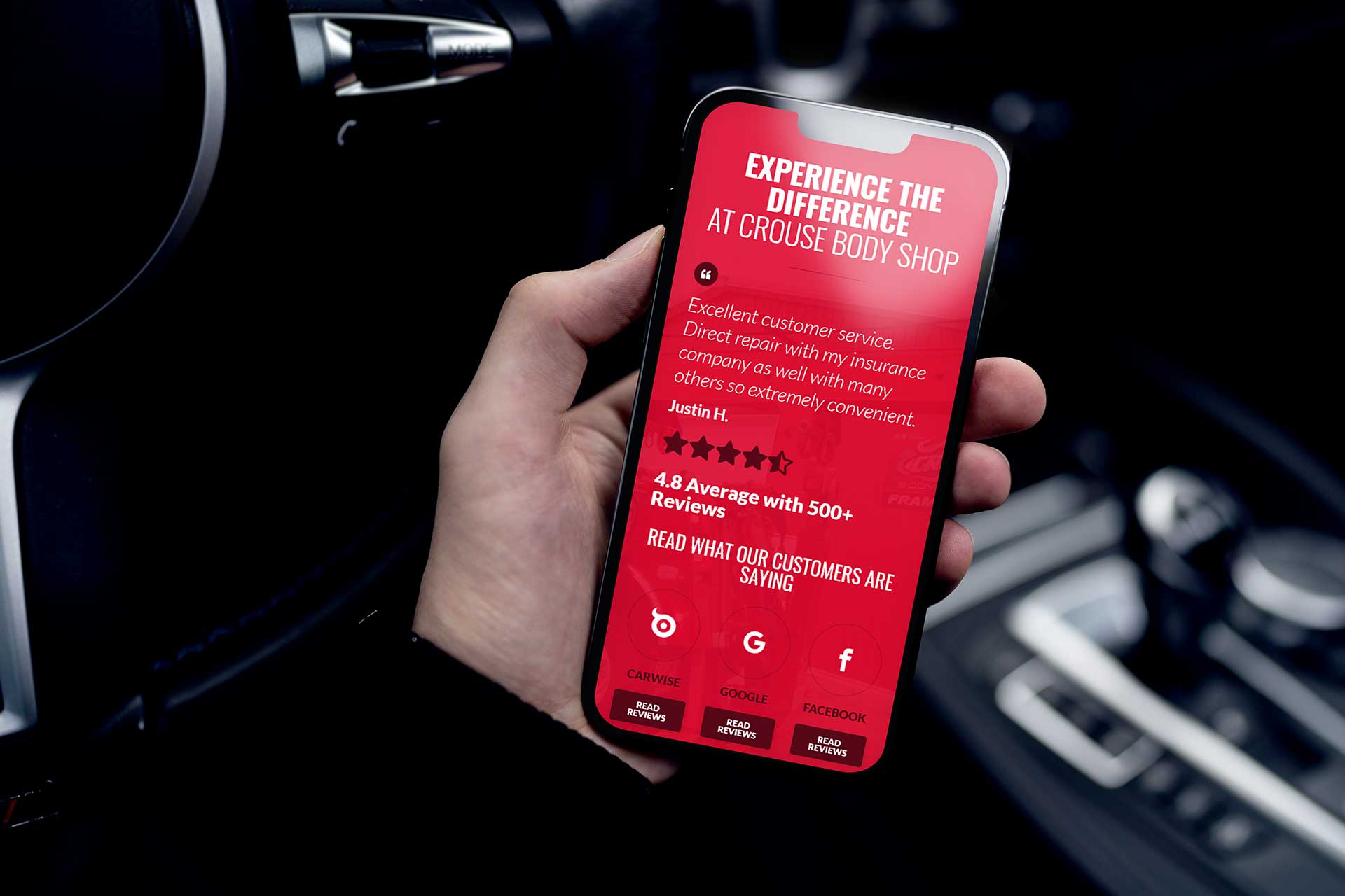 Hand holding a smartphone showing a Crouse Body Shop advertisement.