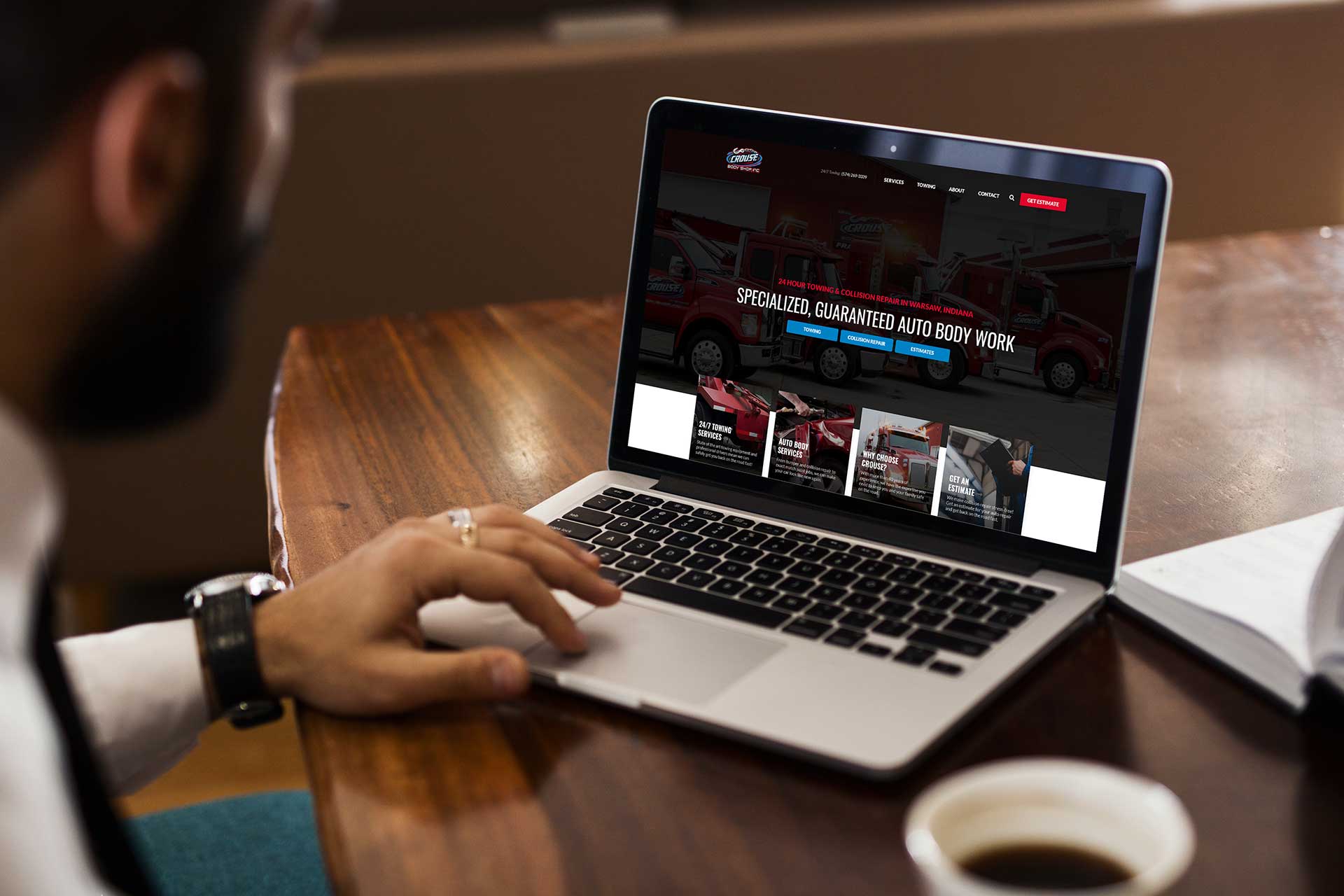 Person browsing Crouse Body Shops website on a laptop.