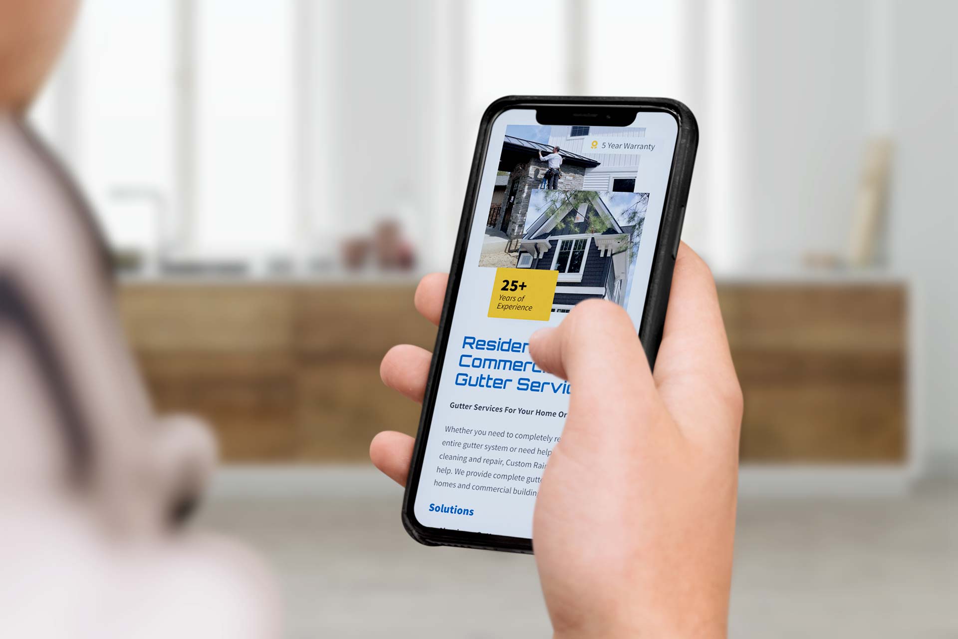 Person scrolling through residential services on a smartphone screen.