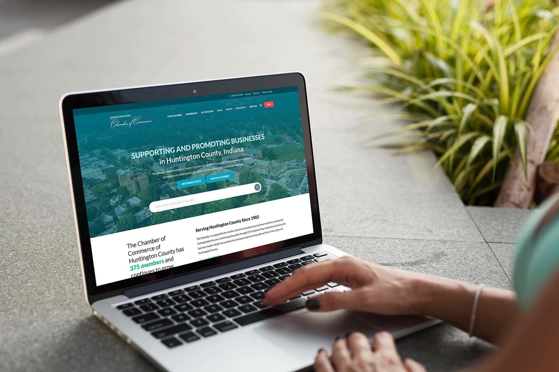 Person browsing the Huntington County Chamber of Commerce website on a laptop.