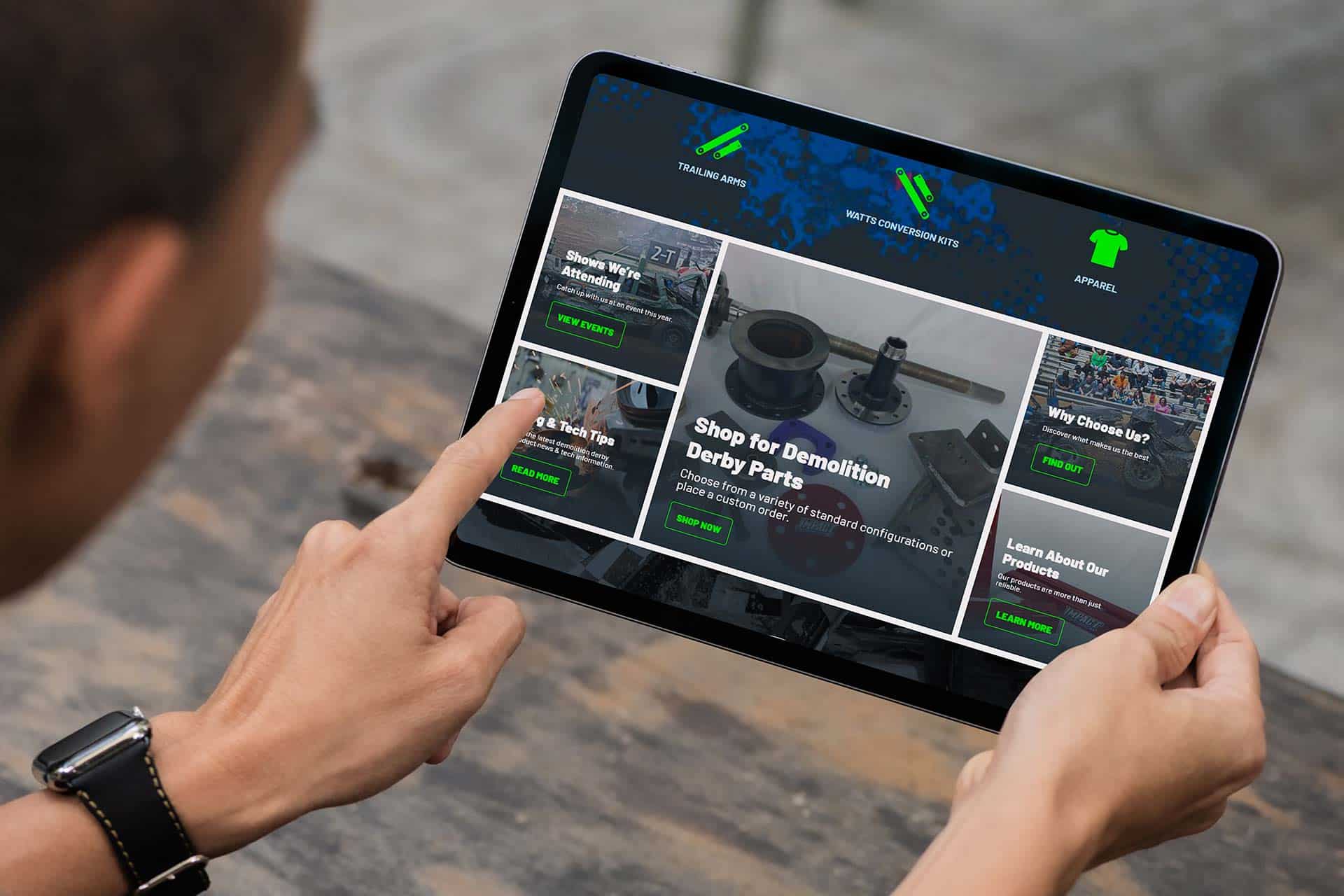 Person browsing Impact Derby Products website on a tablet.