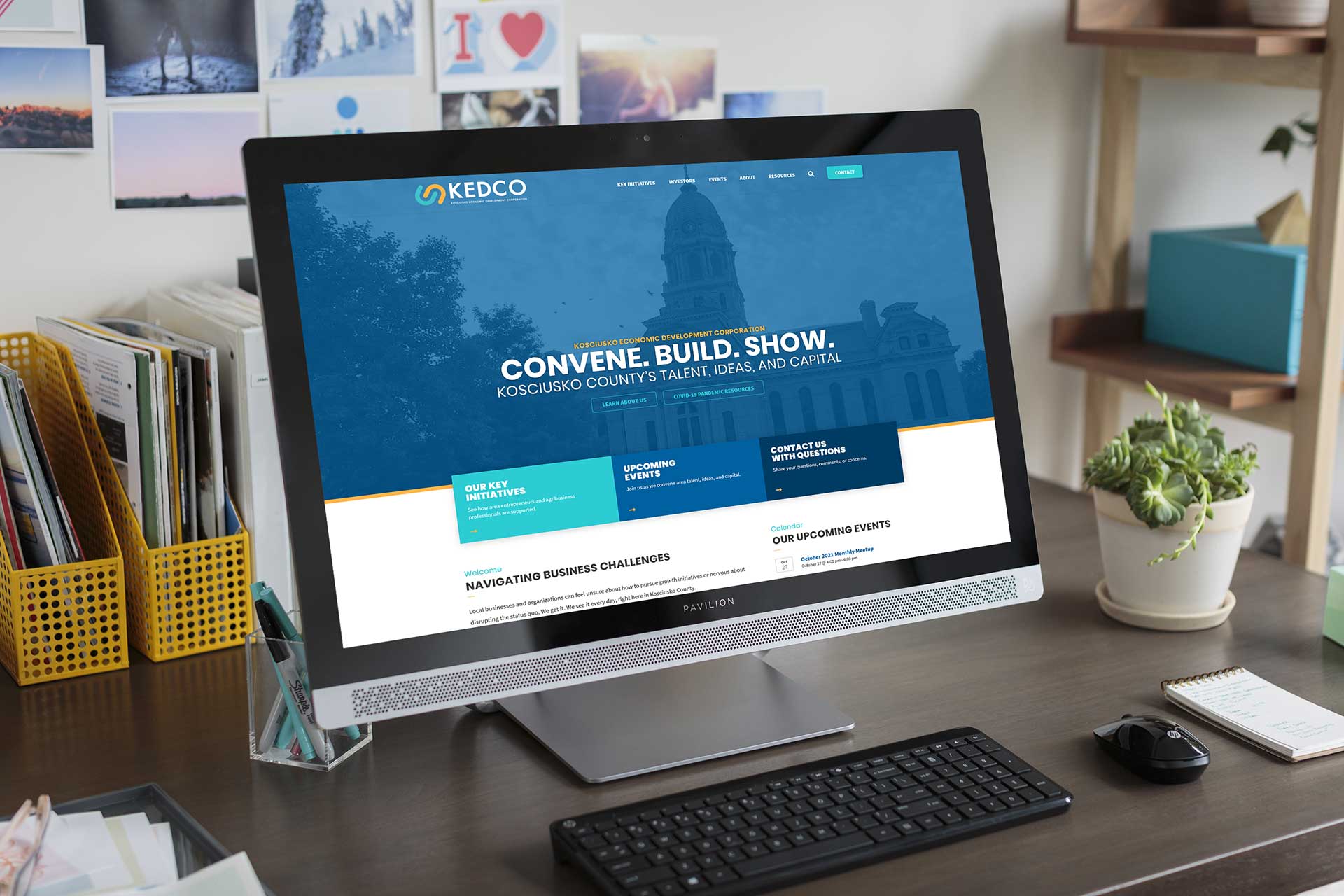 Computer on desk open to KEDCo homepage.