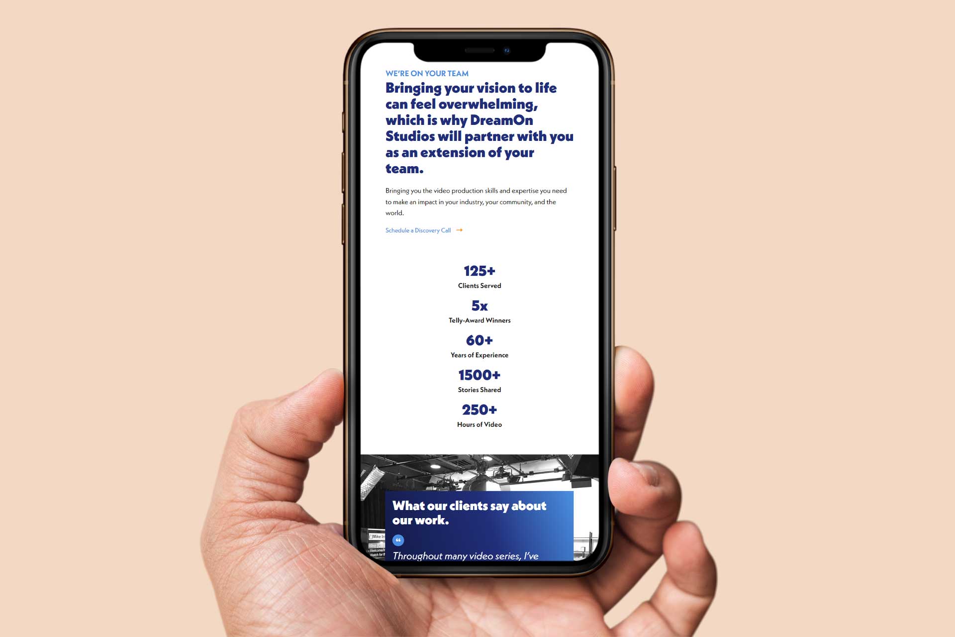 A hand holds a smartphone showing DreamOn Studios service details.