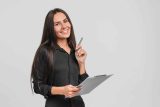 Smiling woman in black shirt with clipboard, ready with marketing tips.