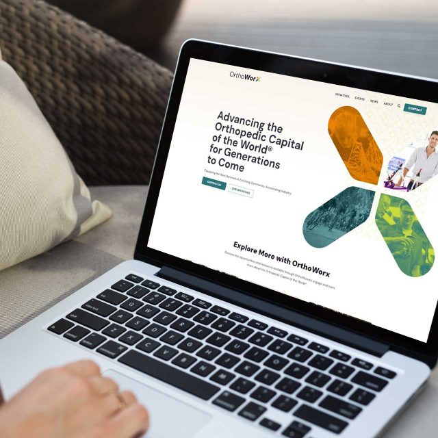 Person browsing OrthoWorx on a laptop, exploring the homepage.