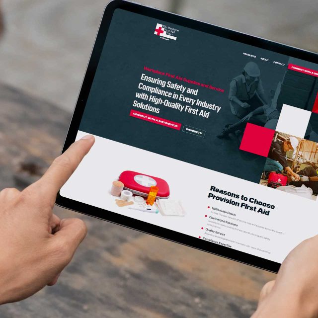 Person with a tablet showcasing the Provision First Aid website.