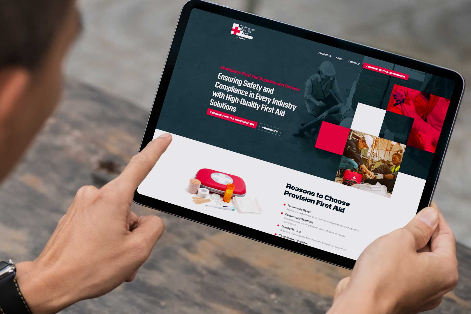 Person with a tablet showcasing the Provision First Aid website.
