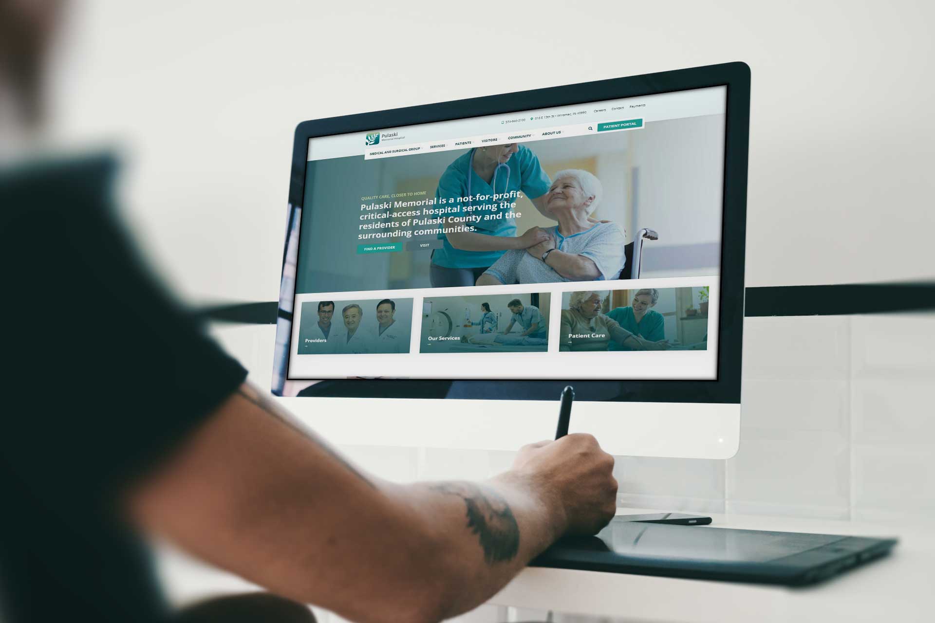 Person using a stylus on Pulaski Memorial Hospitals website on a computer.