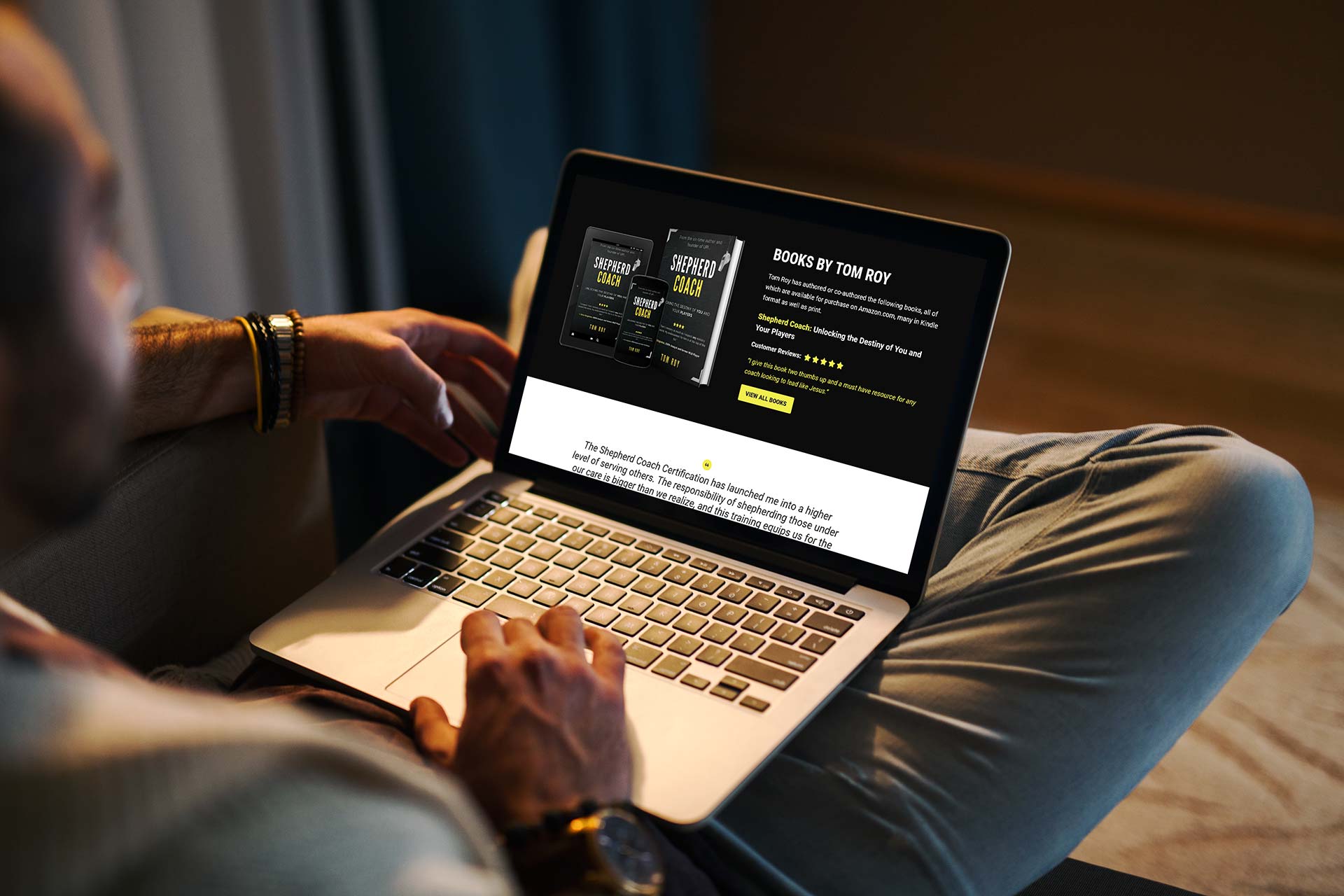 Person browsing Shepherd books on a laptop screen in a dimly lit room.