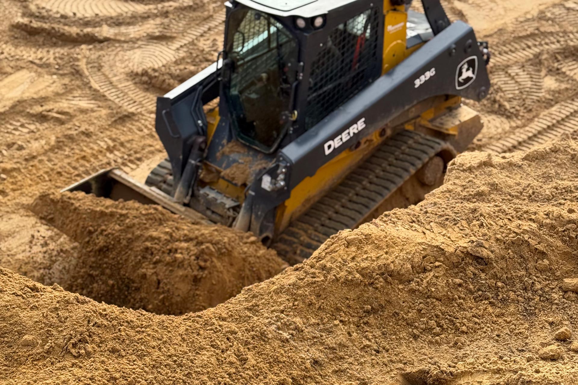 A bulldozer moves sand at a construction site.