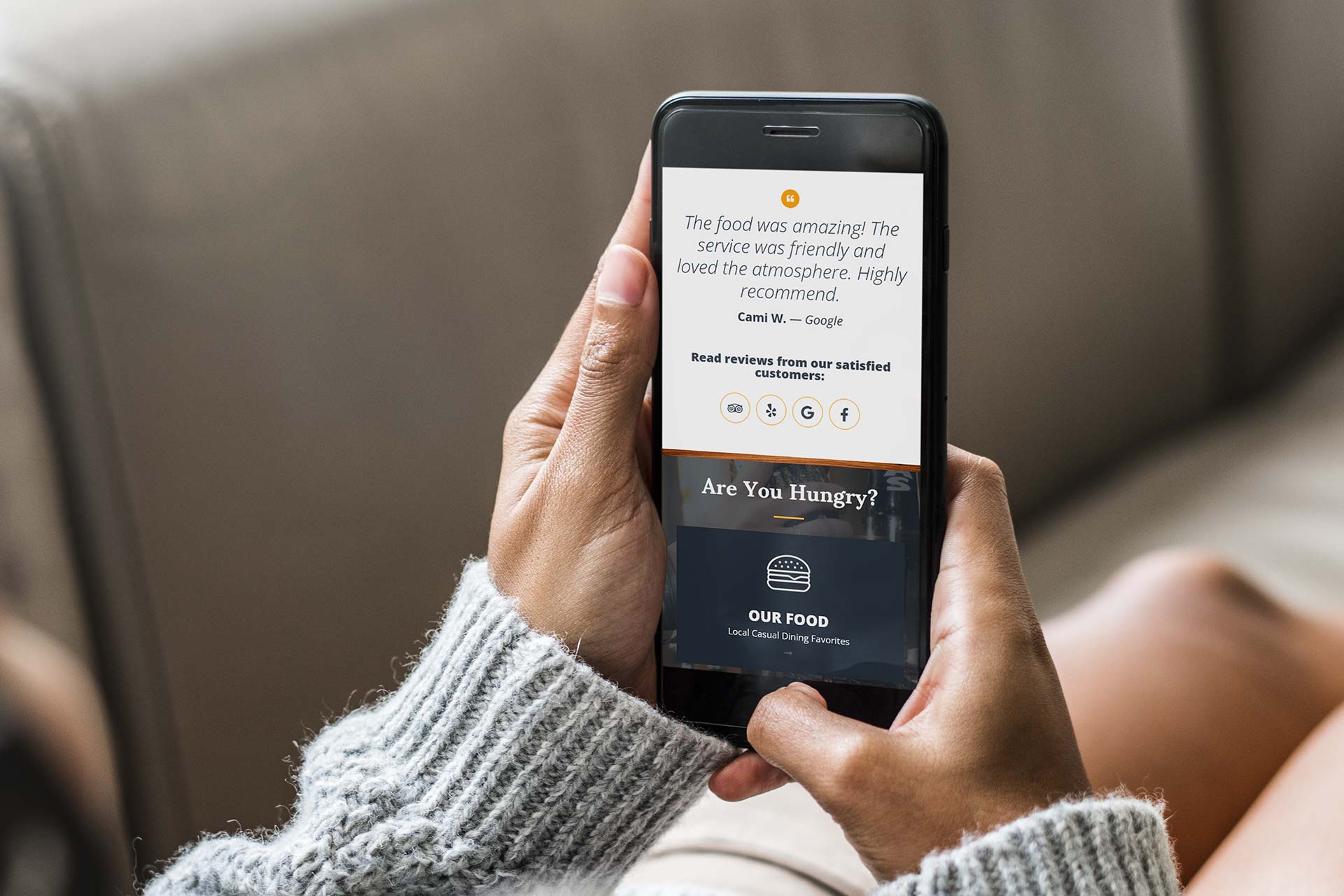 Person holding a phone displaying a restaurant review.